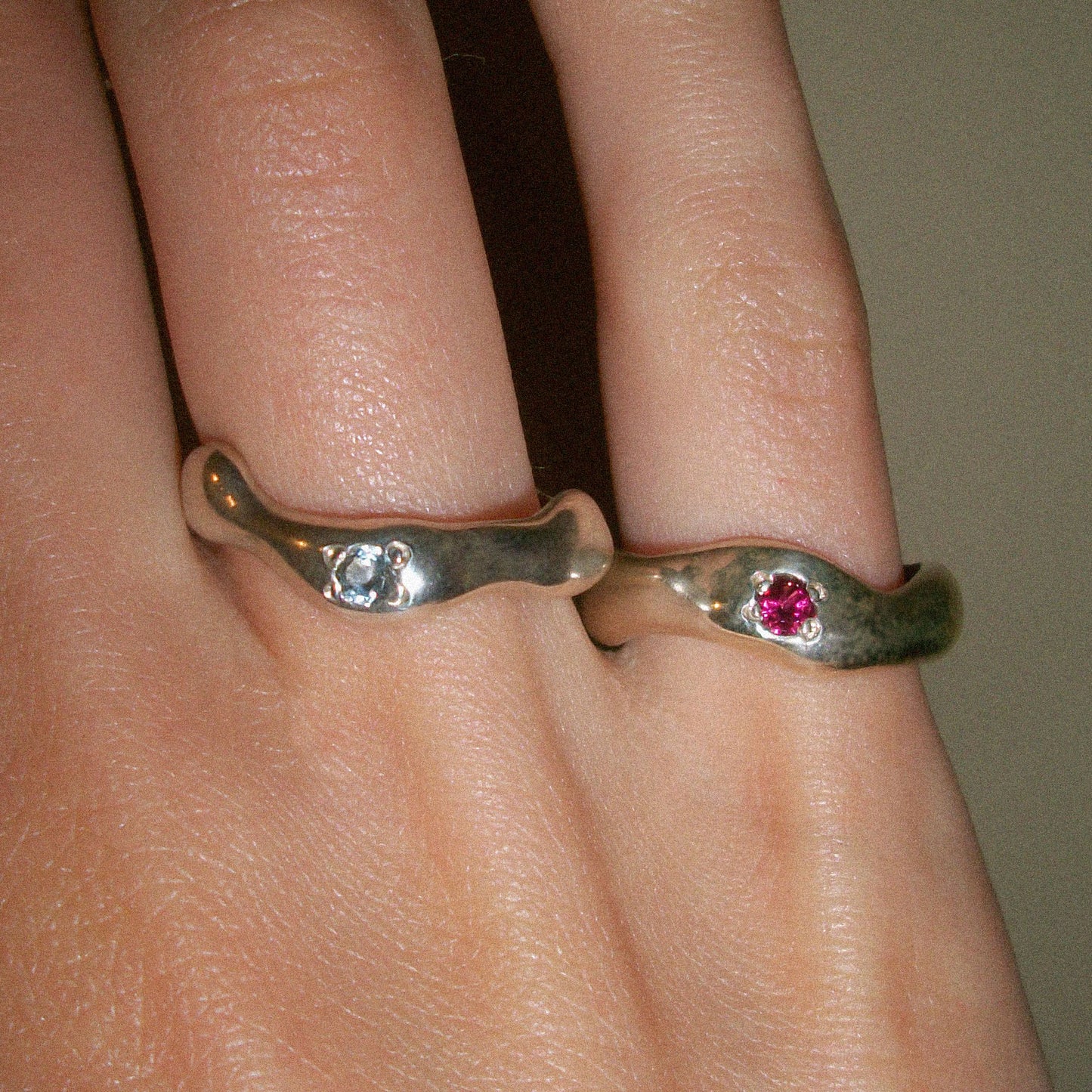 Motion rings with blue and pint topaz.