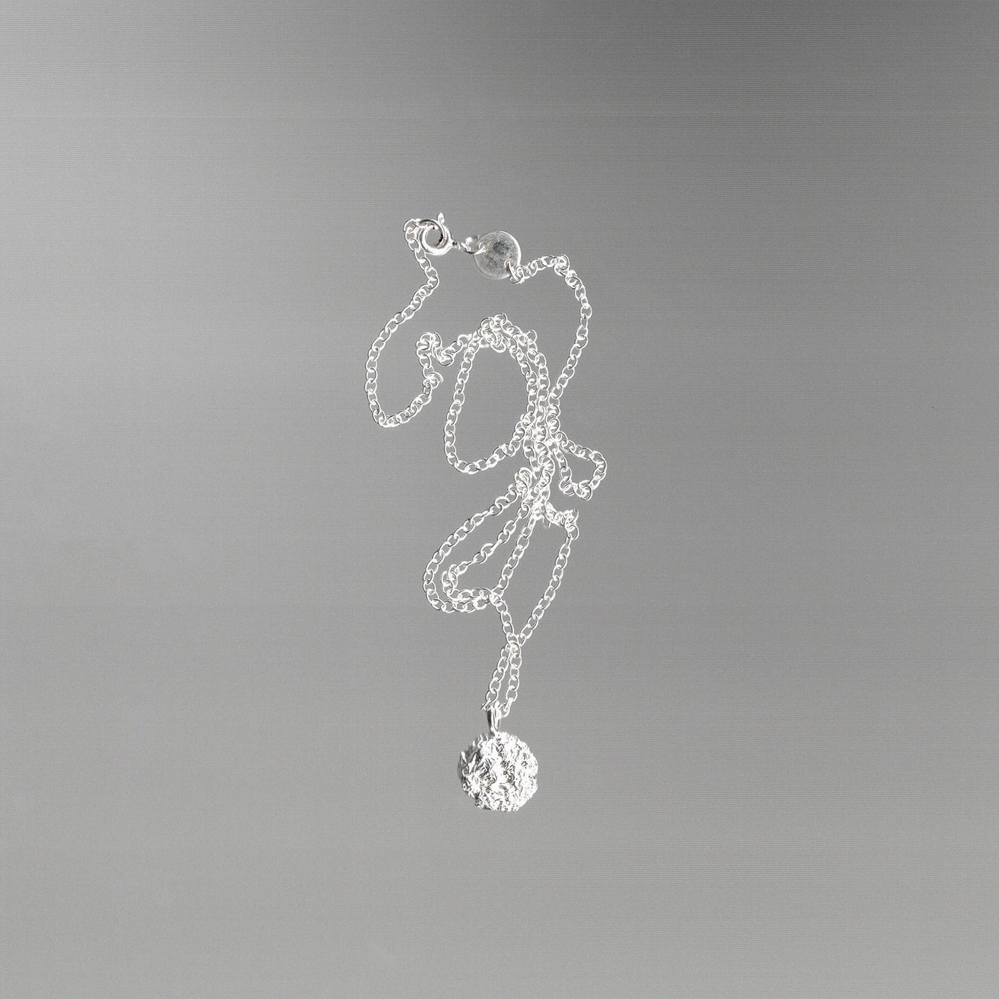 Silver necklace with a foil texture pendant