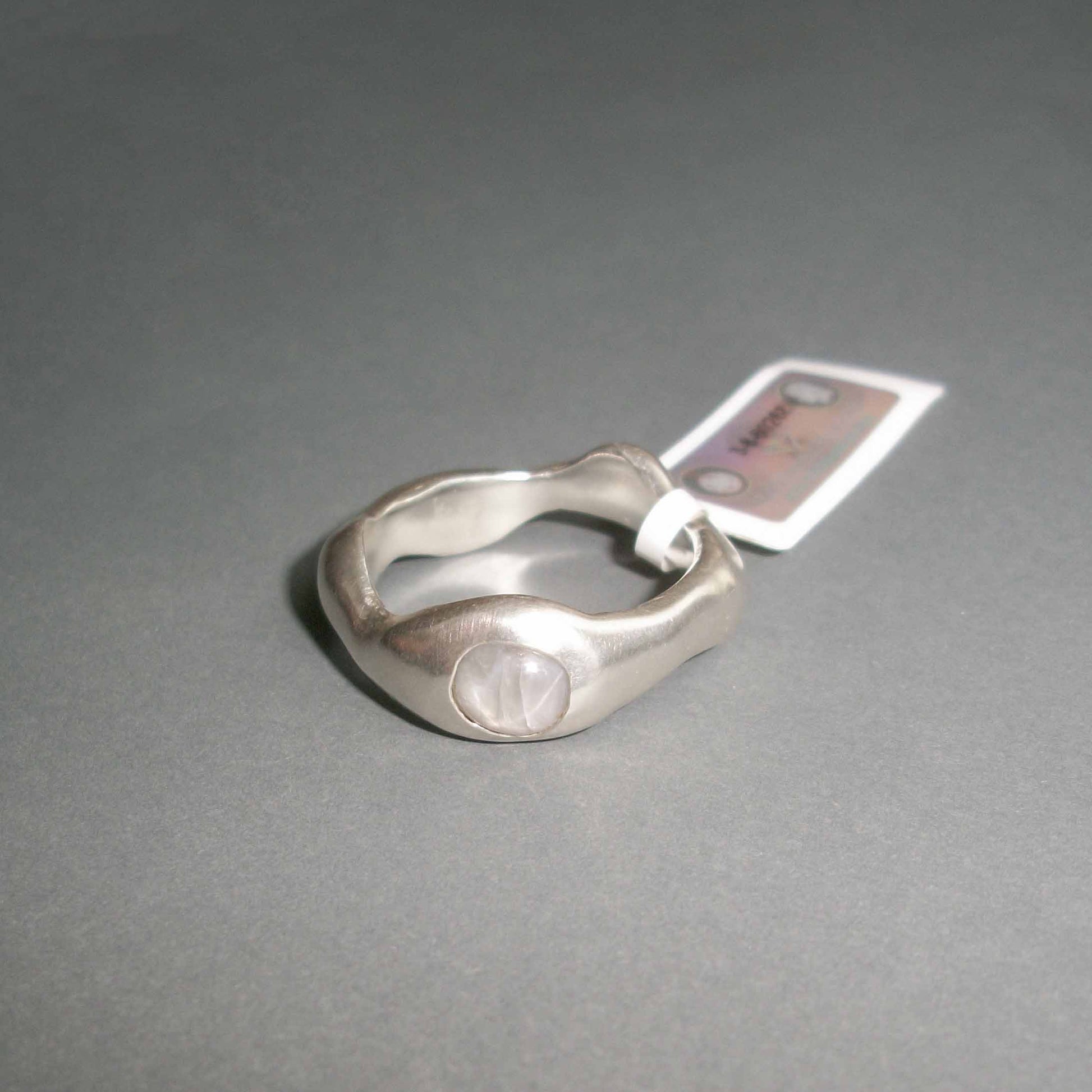 Unique Motion ring with grey star sapphire.