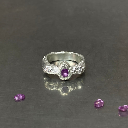 Silver ring with pink sapphire gemstone.