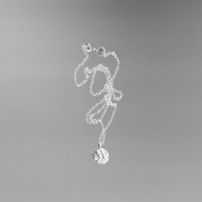 Silver necklace with a foil texture pendant 