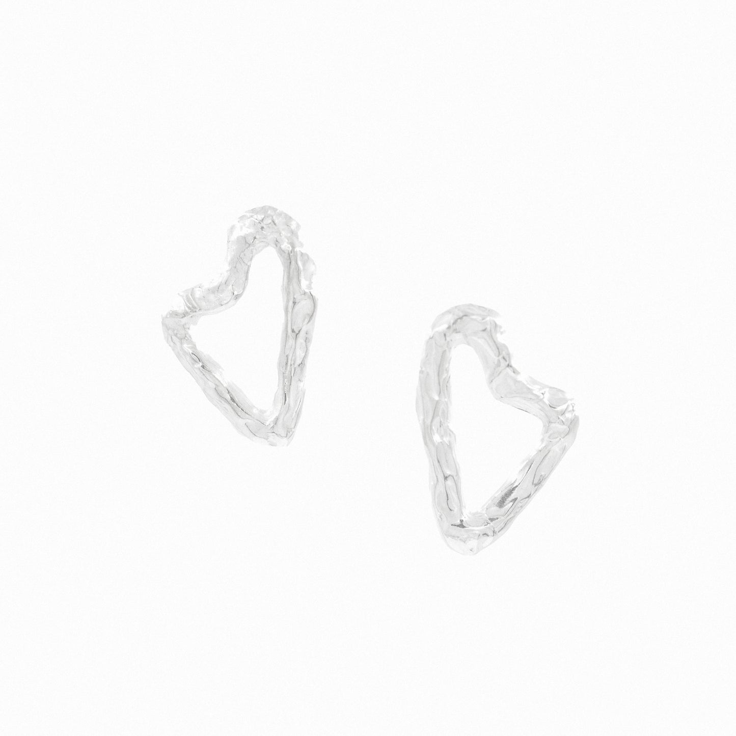 Handmade asymmetric heart earrings.  Front